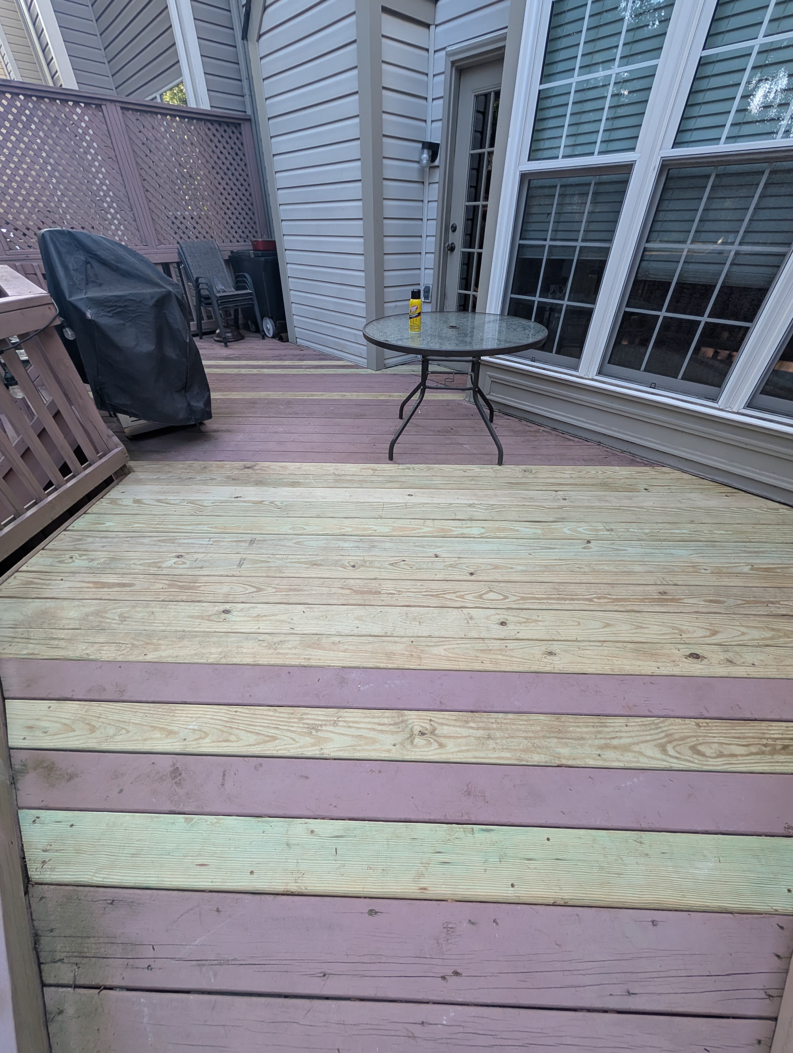 Close view of the privacy lattice screen and string lights on a repaired deck in Sterling